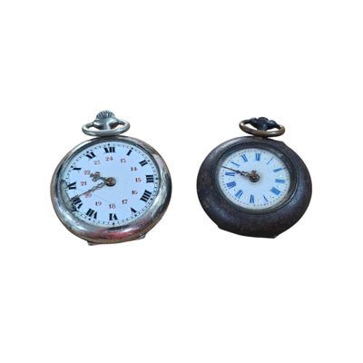 two clocks sitting next to each other on a white surface
