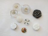 a lot of different glass knobs on a table