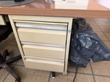 an image of a desk with drawers and a computer on it