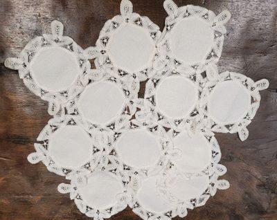 lace doily with white flowers on a wooden surface