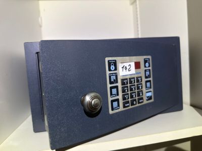 a blue safe box sitting on top of a white shelf