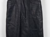 a black leather skirt hanging on a hanger