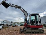 a small excavator that is sitting in the dirt