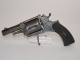 an old revolver with a wooden handle on a white surface