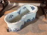 a blue and white bath tub sitting on the floor