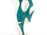 a green and white sculpture of a bird on a base