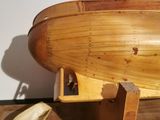 a wooden boat that is on display on the floor