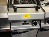 a grill that is sitting in the middle of a kitchen