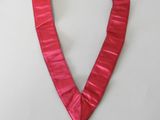 pink ribbon with a gold medal attached to it