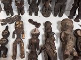 a lot of wooden figurines that are on a table