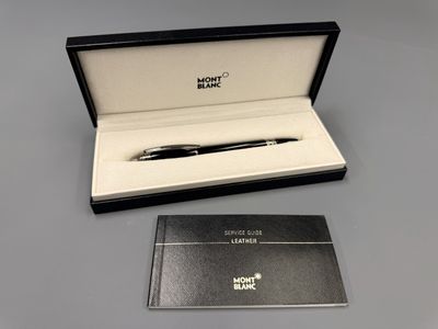 a black box with a pen and a notepad in it