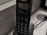 a phone that is sitting on a desk near a window