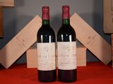 two bottles of wine sitting next to each other on a table