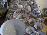 a table that has a lot of dishes and cups on it