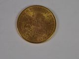 a close up of a gold coin on a white surface