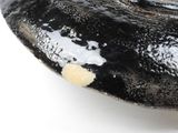 a close up of a black and white object on a white surface