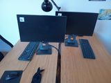 two computer monitors and a keyboard on the desk