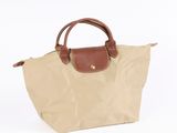 the longchamp bag in beige with brown handles