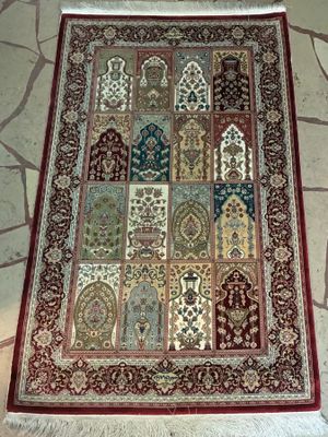 a rug on the floor that has many different designs on it