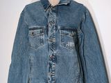 denim jacket on a mannequin dummy with a white background