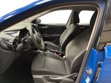 the interior of a blue car with the door open and the driver ' s seat down