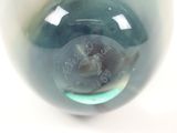 a close up of a glass vase with a blue and green design