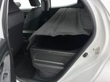 a car with the trunk open and a luggage bag in the back