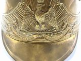 a gold helmet with an eagle emblem on it