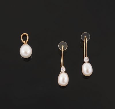 three pairs of pearl and diamond earrings on a black surface