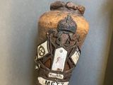a baseball bat with a sticker on it next to a bat holder