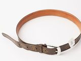 the belt is brown and has a silver buckle on it