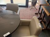 a table and chairs in a room with a large window