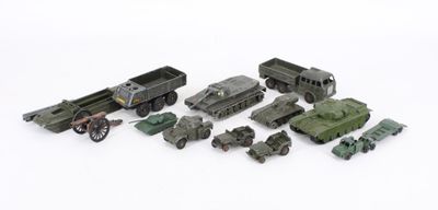 a lot of toy army vehicles and trucks on a white surface