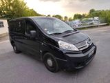 a small black van that is parked in the parking lot