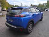 the rear end of a blue suv parked in a parking lot