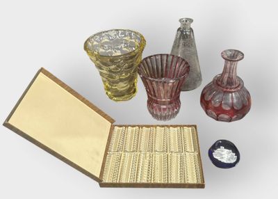 a lot of glass vases and a box on the table