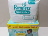 two boxes of baby diapers sitting on top of each other