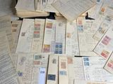 a pile of old letters and stamps on a table
