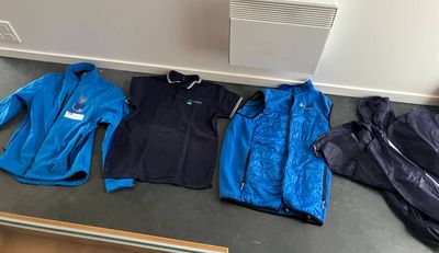 several jackets and jackets are lined up on the floor