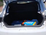 trunk of a white car with luggage in the back of it
