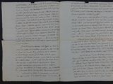 an old handwritten letter on a piece of paper on a table
