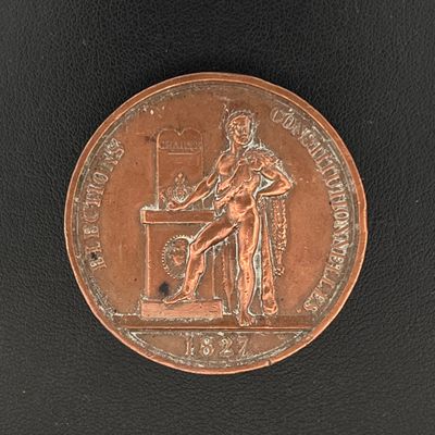 une image représentant une médaille de bronze sur laquelle figure un homme assis à un bureau