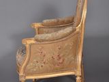 pair of louis xvi style armchairs with floral upholstered cushions