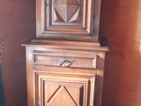 a wooden cabinet in the corner of a room