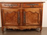 an old wooden cabinet with two doors and a drawer on top of it