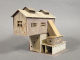 a small model of a house with a roof and two windows