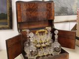 a wooden box with a glass set inside of it