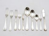 five forks and five spoons on the table