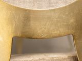 a close up view of a chair with a gold finish
