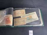 several different types of currency are in a book on a table